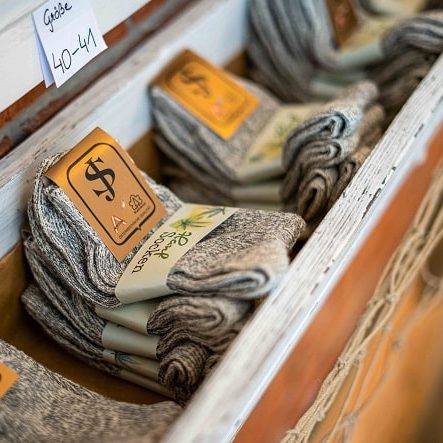 Melierte graue Hanf Socken Größe 40-41, gestapelt in Holzkiste mit Etikett